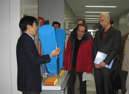 "French scientists receive explanations on multiple probe SPMs from Dr. Nakayama, Director of Electro-Nanocharacterization Group." Image